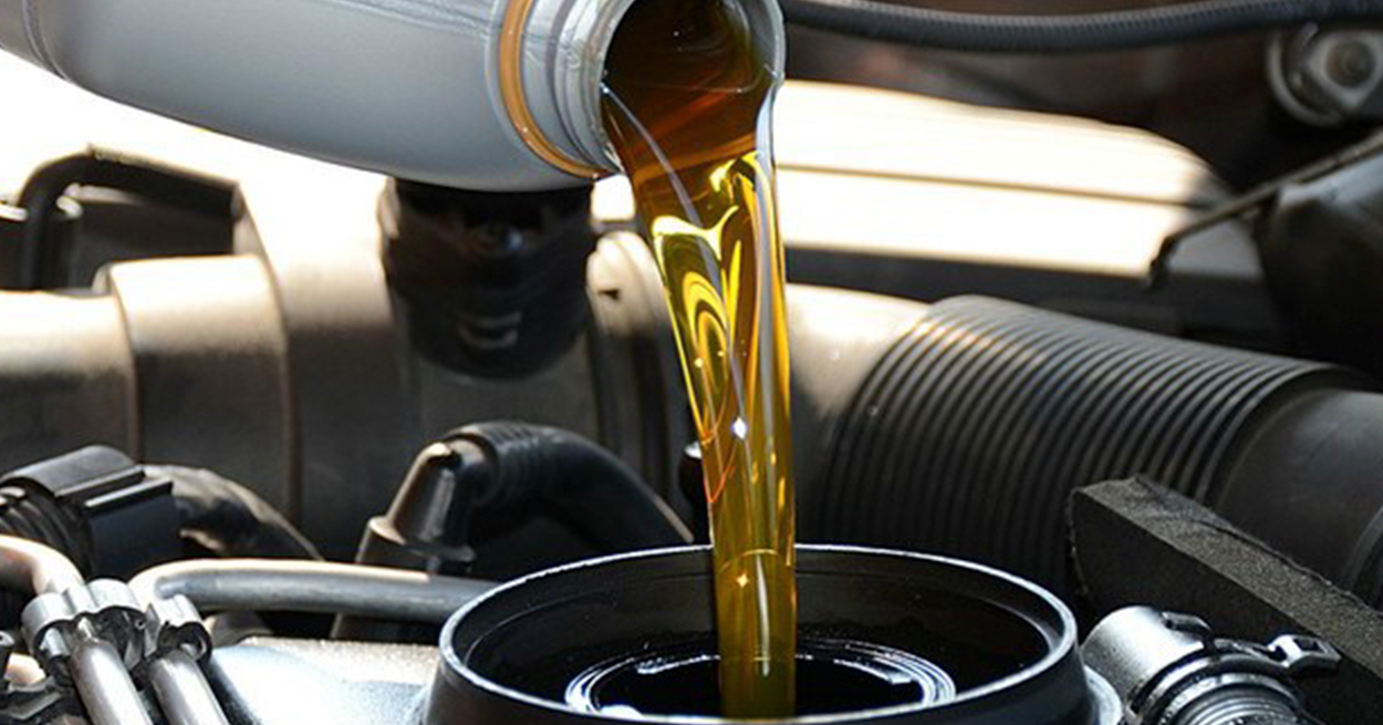 Oil being poured into car engine